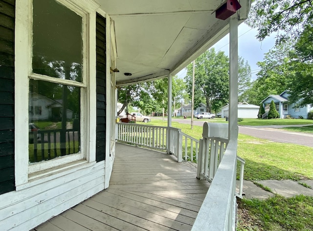 deck featuring a yard and a porch