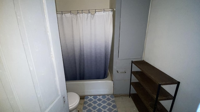 bathroom featuring shower / tub combo and toilet