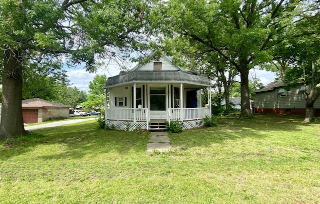 view of front of property with a front yard and covered porch