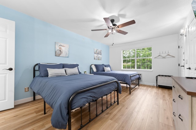 bedroom with light hardwood / wood-style flooring and ceiling fan