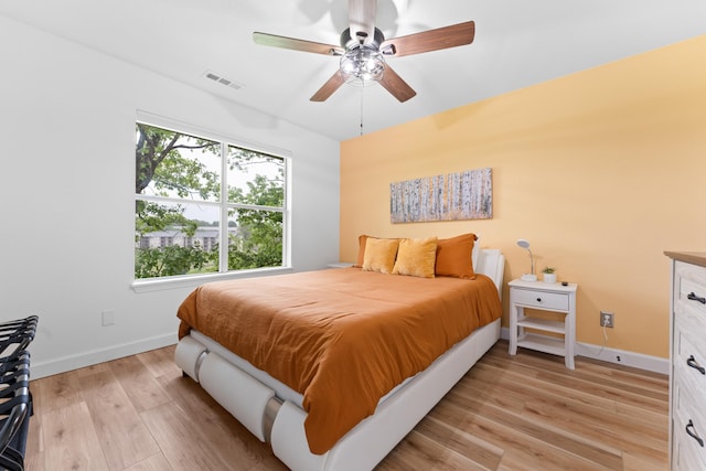 bedroom with light wood-type flooring and ceiling fan