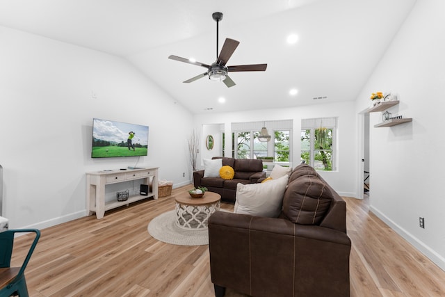 living room featuring ceiling fan, light hardwood / wood-style flooring, and vaulted ceiling