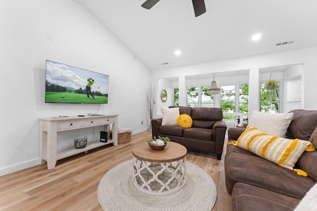 living room with high vaulted ceiling, light hardwood / wood-style flooring, and ceiling fan