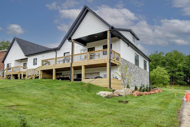 back of property featuring a wooden deck and a lawn