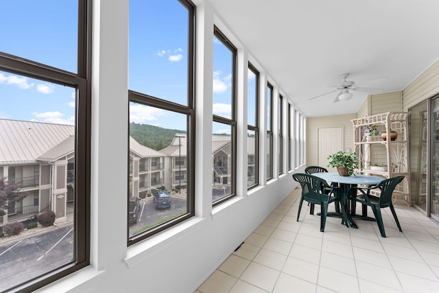 sunroom featuring a wealth of natural light and ceiling fan