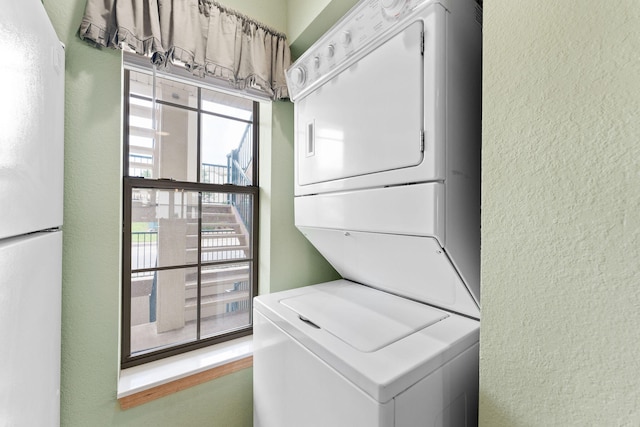 clothes washing area with stacked washer and clothes dryer