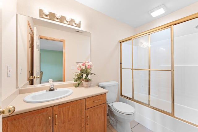 full bathroom featuring combined bath / shower with glass door, tile patterned floors, vanity, and toilet