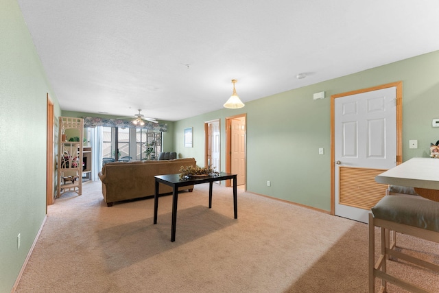 living room featuring ceiling fan and light colored carpet