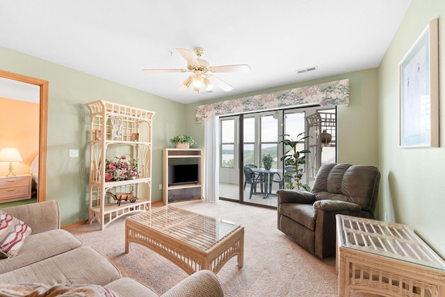 living room with ceiling fan and light colored carpet