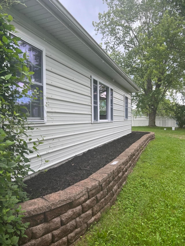 view of side of property with a lawn