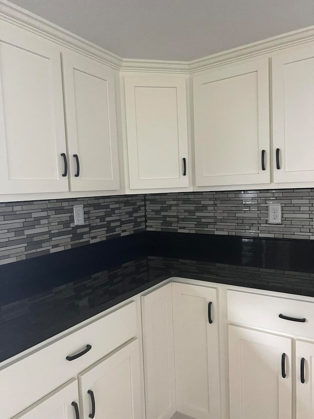 kitchen with white cabinetry and tasteful backsplash