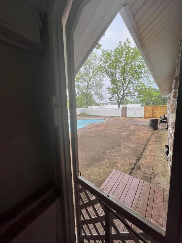 exterior space with a patio, central AC unit, and a fenced in pool