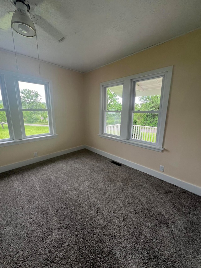 spare room with ceiling fan and carpet floors