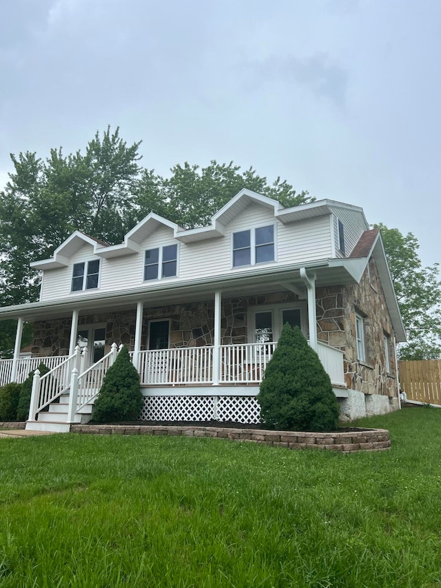 view of front of house with a front yard and covered porch