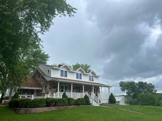 view of front of property with a porch and a front yard