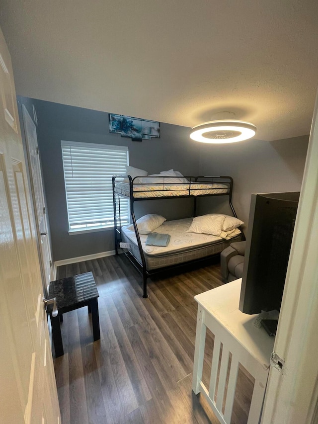 bedroom with dark wood-type flooring and a textured ceiling