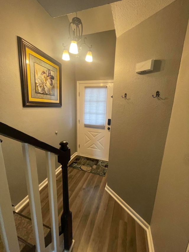 entryway featuring a notable chandelier and hardwood / wood-style flooring