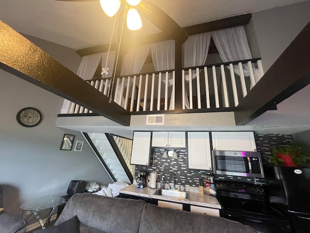 living room featuring sink and ceiling fan