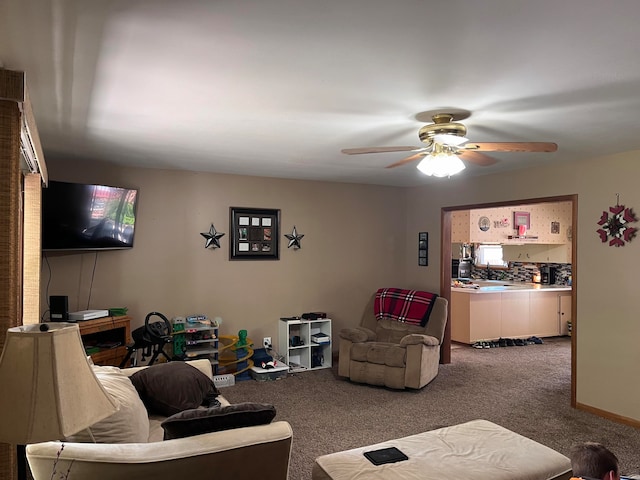 living room with ceiling fan and carpet