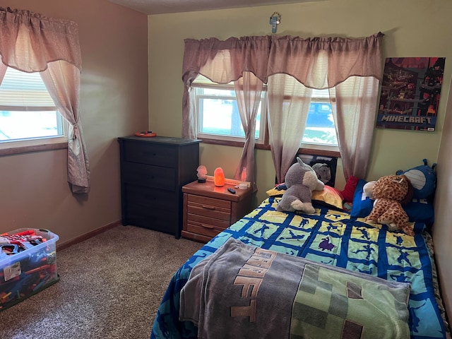 bedroom with carpet and multiple windows