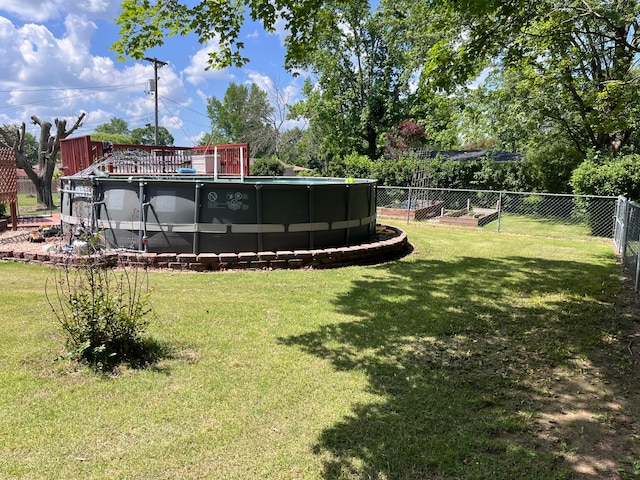 view of yard with a fenced in pool