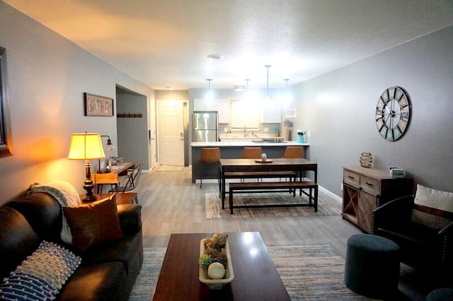 living room featuring light hardwood / wood-style flooring and sink