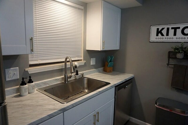 kitchen with sink, white cabinetry, and stainless steel dishwasher