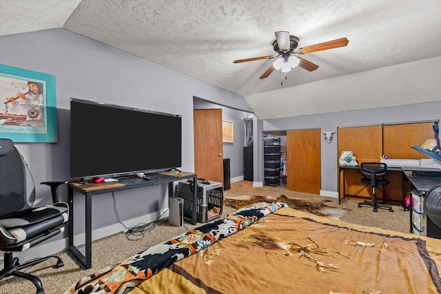 office with ceiling fan, vaulted ceiling, a textured ceiling, and light carpet