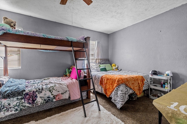 carpeted bedroom with a textured ceiling and ceiling fan