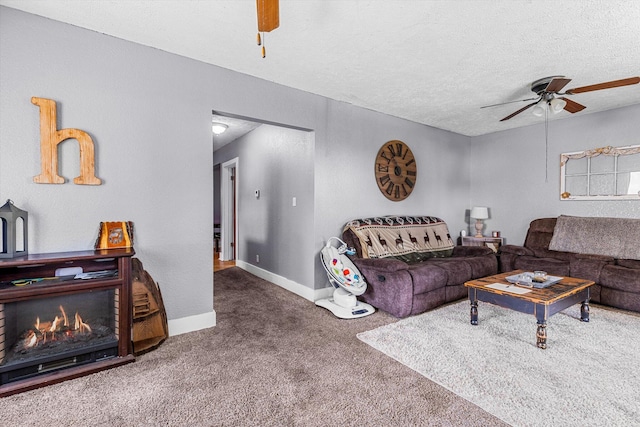 carpeted living room featuring ceiling fan and a textured ceiling