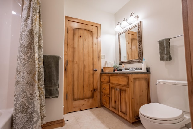 bathroom featuring tile patterned floors, toilet, and vanity