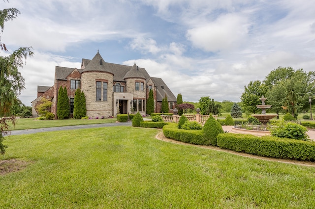 french country style house with a front yard