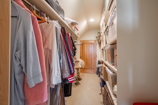 spacious closet with carpet floors and lofted ceiling