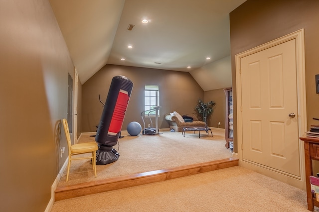 workout area featuring light carpet and lofted ceiling