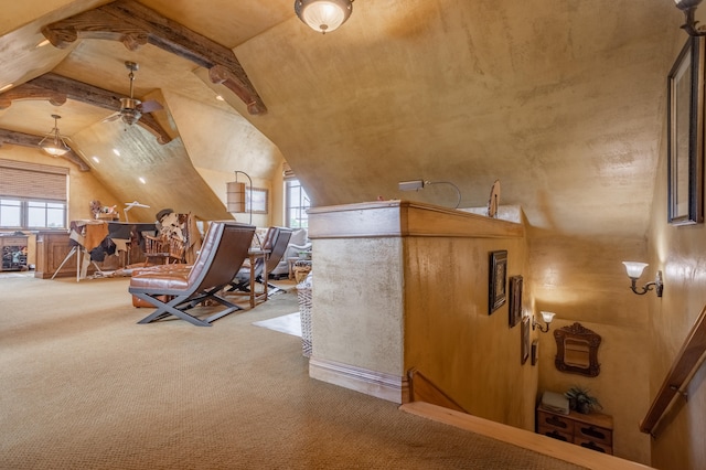 interior space featuring ceiling fan, lofted ceiling, a wealth of natural light, and carpet