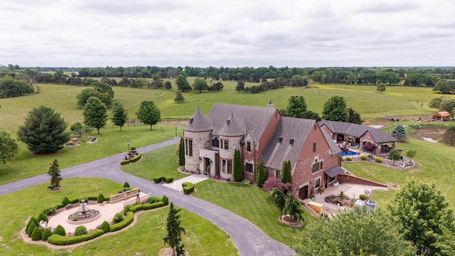 birds eye view of property with a rural view