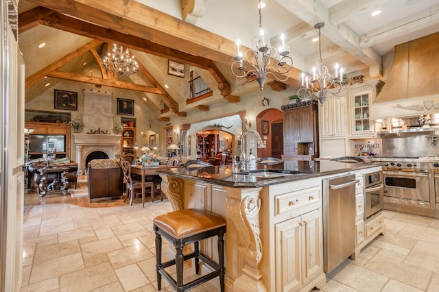 kitchen with beamed ceiling, sink, a center island with sink, decorative light fixtures, and a kitchen breakfast bar