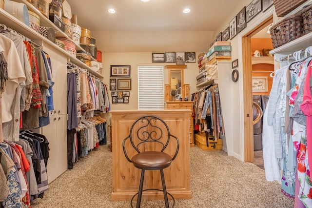 spacious closet featuring light carpet and washer / dryer