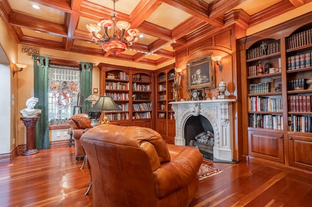 living area featuring a fireplace, built in features, and hardwood / wood-style floors