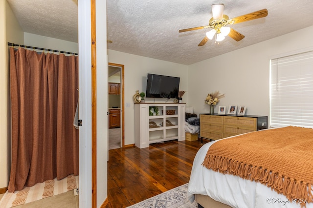 bedroom with hardwood / wood-style floors, baseboards, a textured ceiling, and ceiling fan