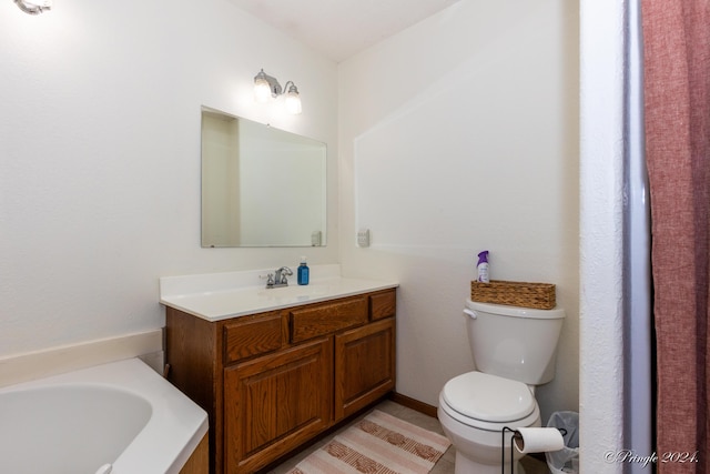bathroom with a washtub, toilet, and vanity