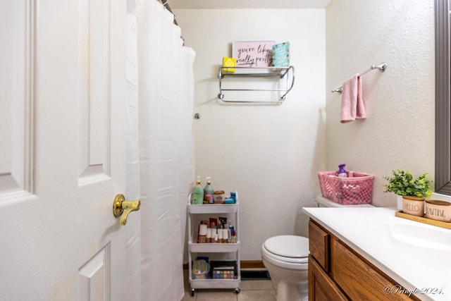 bathroom with tile patterned floors, toilet, and vanity