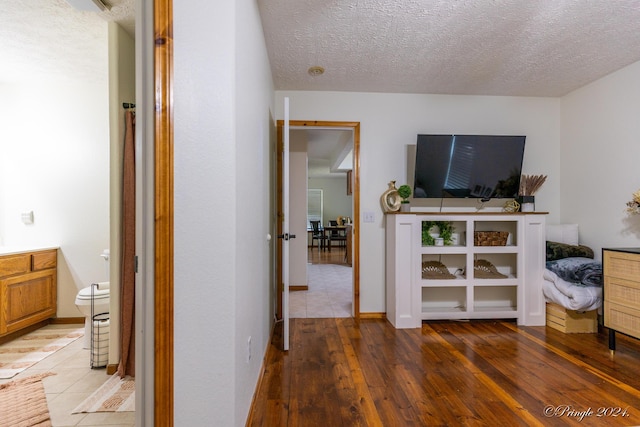 interior space with wood-type flooring and a textured ceiling