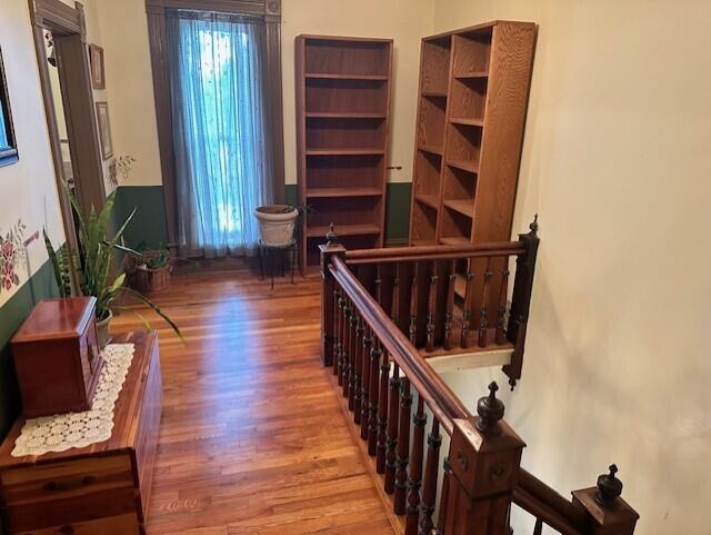 624 S Ash St, Nevada, MO 64772 - interior space featuring wood finished floors and an upstairs landing