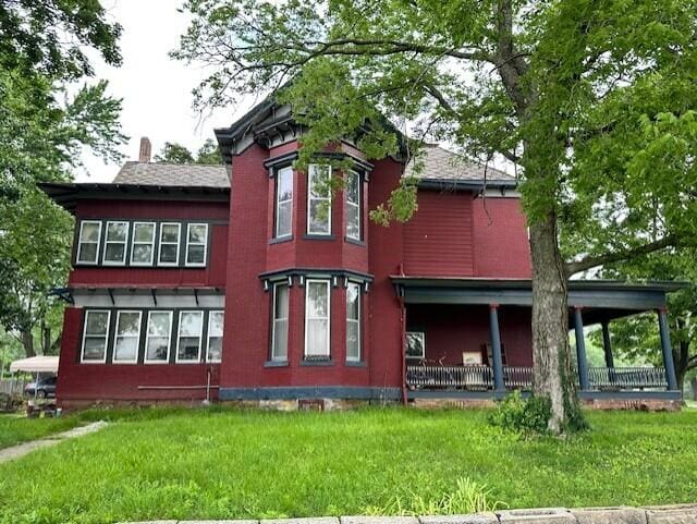 624 S Ash St, Nevada, MO 64772 - rear view of house with a yard and a chimney