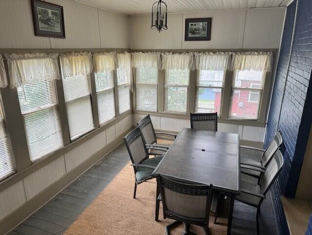 dining space featuring hardwood / wood-style flooring and a healthy amount of sunlight