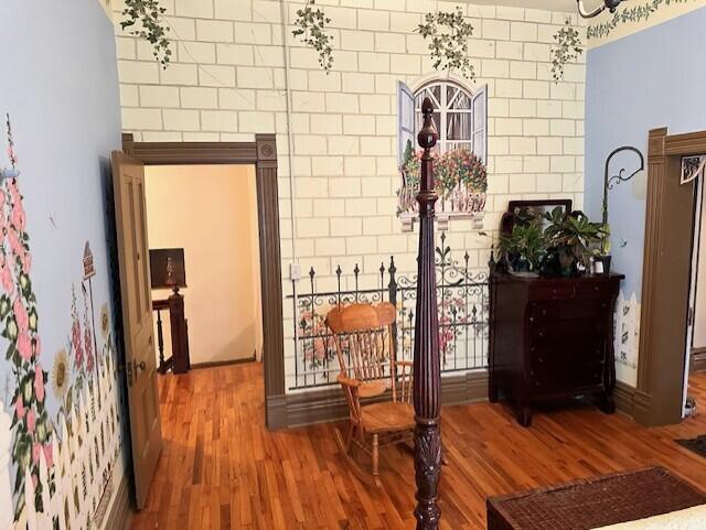 hallway with hardwood / wood-style flooring