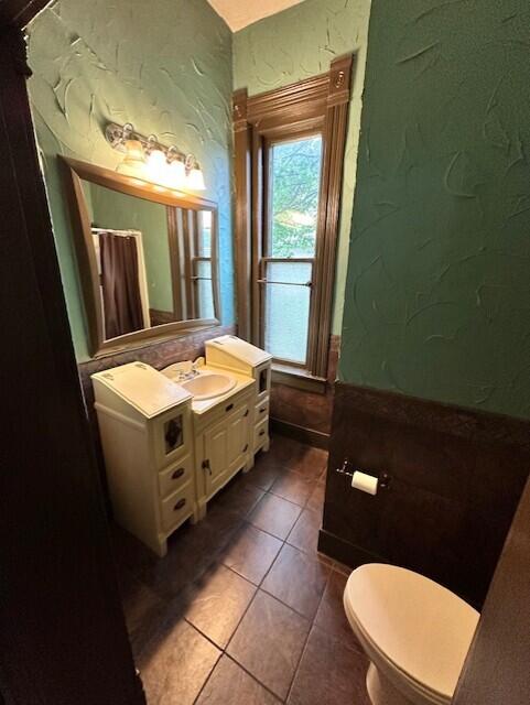 624 S Ash St, Nevada, MO 64772 - bathroom with vanity, tile patterned flooring, and toilet