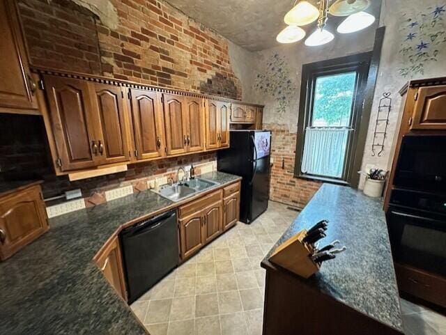 kitchen featuring pendant lighting, sink, brick wall, black appliances, and an inviting chandelier