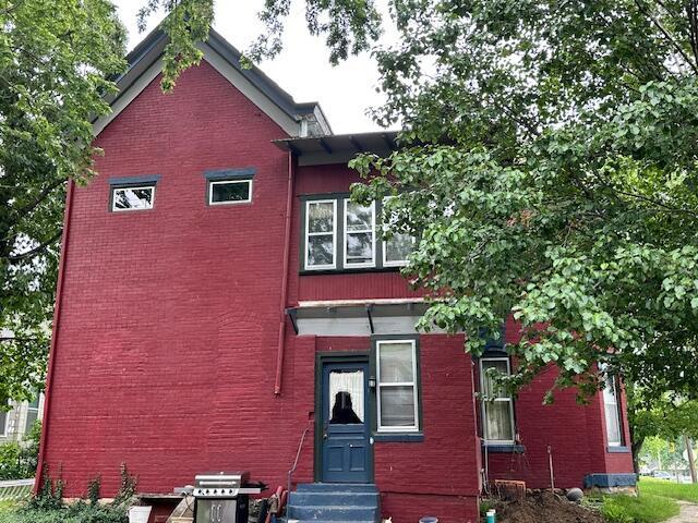 624 S Ash St, Nevada, MO 64772 - view of front of house with brick siding and entry steps